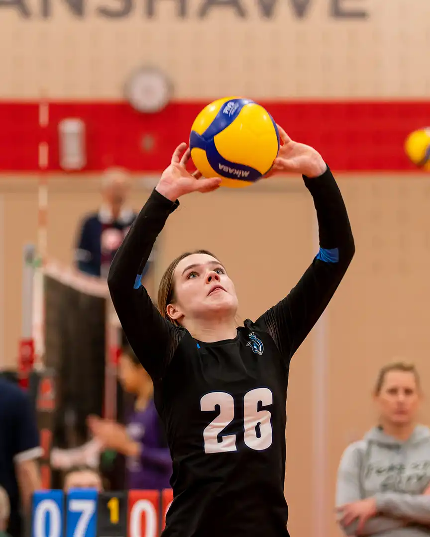 titans volleyball rep and club A girl setting a volleyball